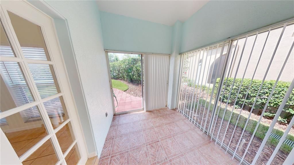 Enclosed Sun Room leads to the back patio.