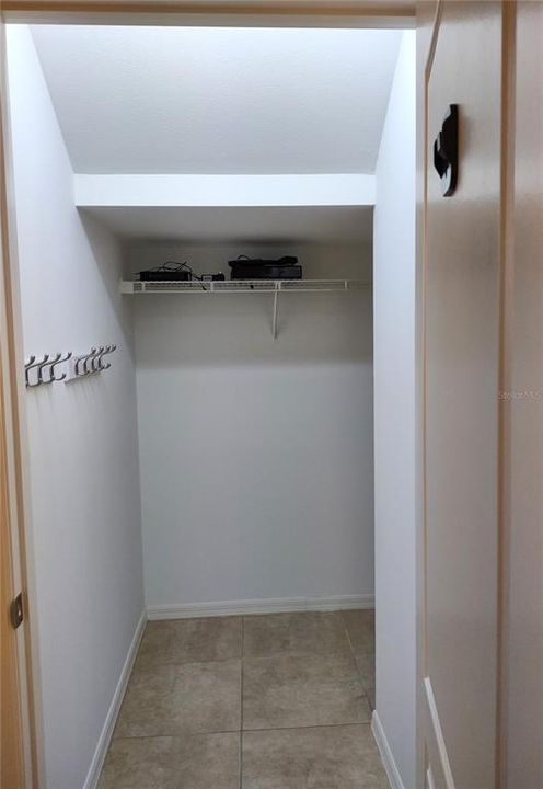 Spacious Walk-In Coat Closet with extra storage beneath the staircase on the first floor located next to the front entry.