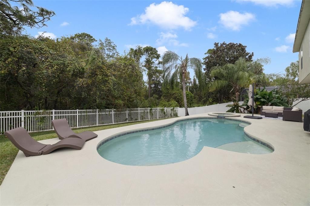 The spa is the perfect place to relax and unwind, there is ample patio space for seating and the large backyard is FULLY FENCED for added privacy while still being able to enjoy the WOODED VIEW!