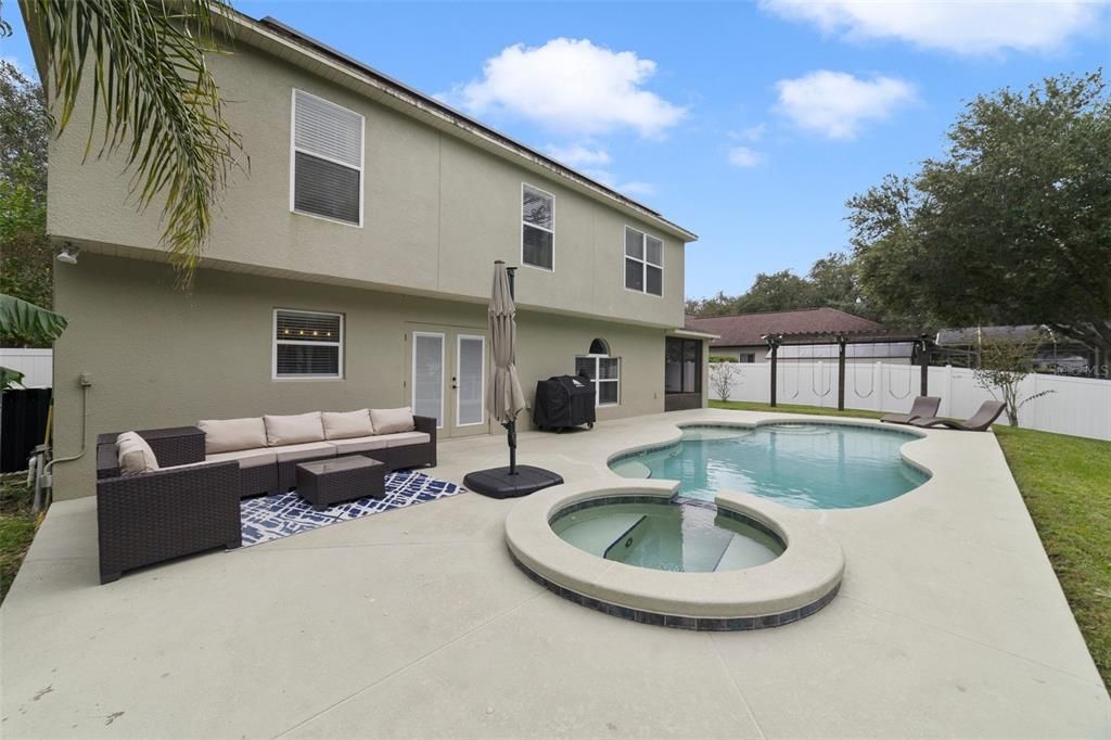 The backyard is an entertainer’s dream with a SCREENED LANAI on the side of the home perfect for weekend cookouts after spending the day splashing in your heated salt water pool.