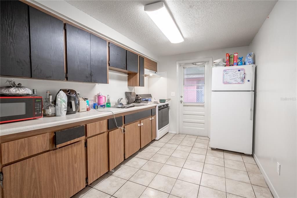 The kitchen features a refrigerator/freezer and range.