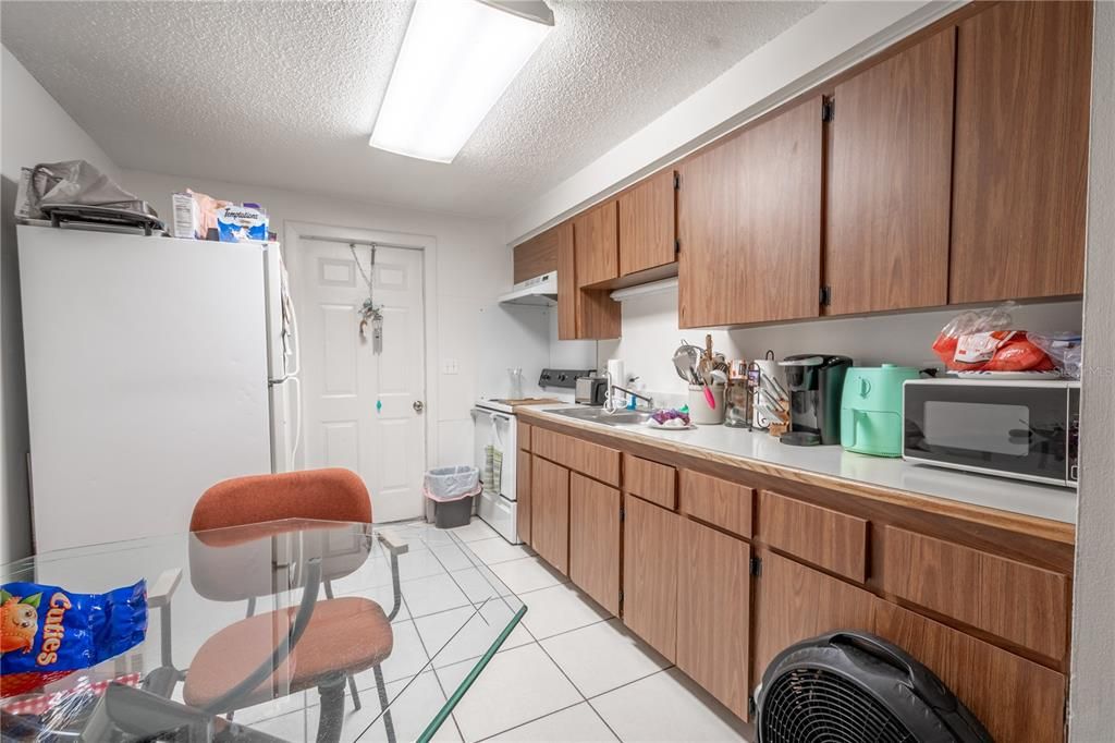 UNIT A  the kitchen features a refrigerator/freezer and range.