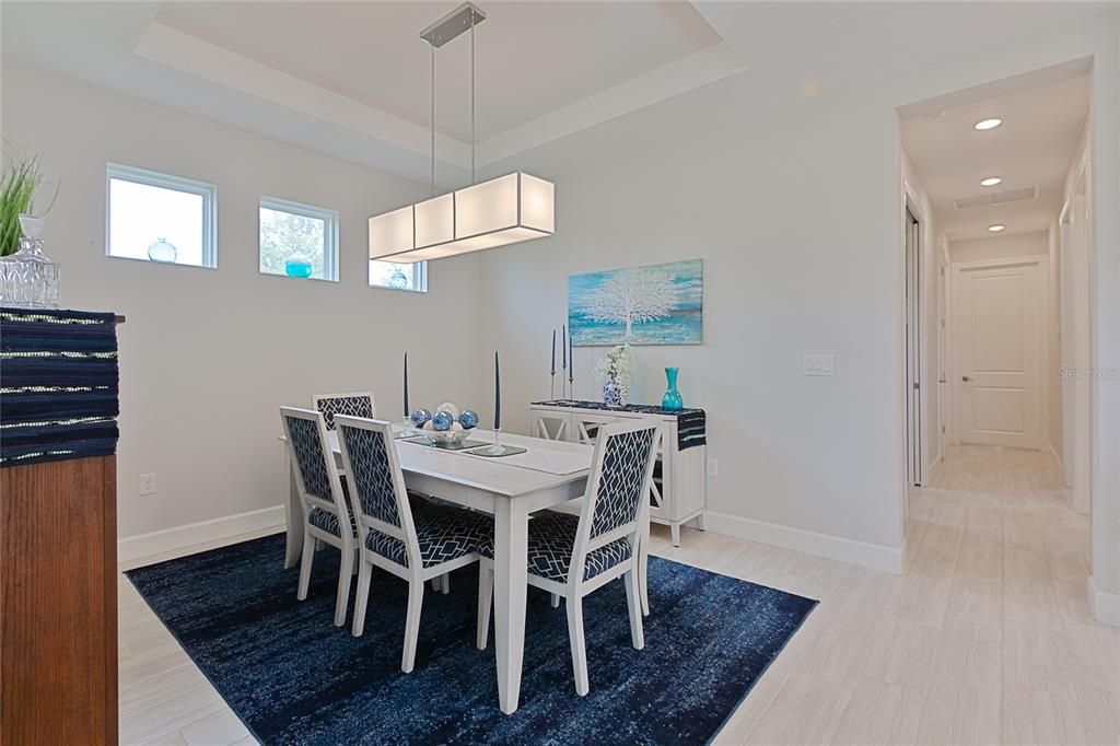 roomy living room with accent windows and designer light fixture