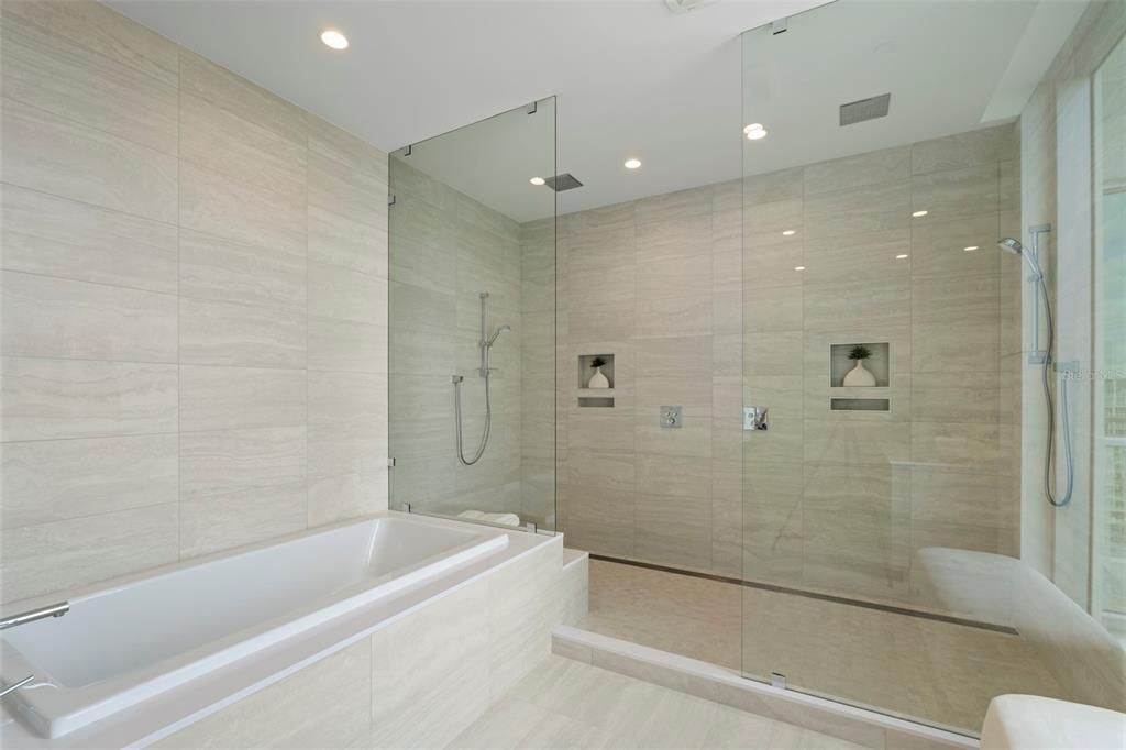 It rivals that of a luxury spa with a serene soaking tub, multi-jetted glass and porcelain surround walk-in shower