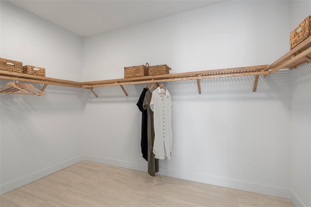 The primary suite features two large walk-in closets