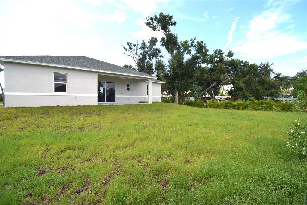 Back view of property and backyard