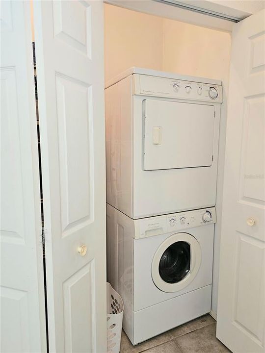 Laundry closet with storage shelves