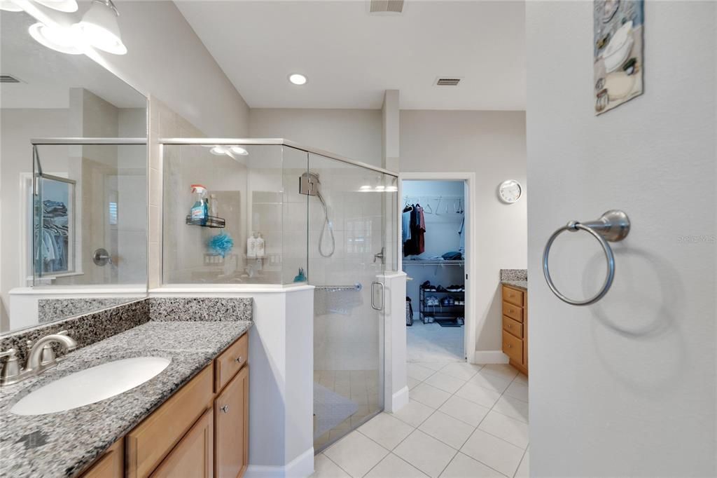 Primary bathroom; separate vanities and step-in shower