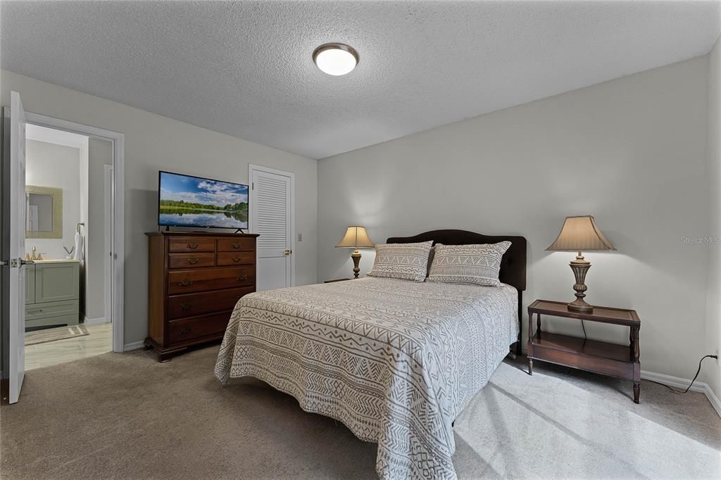 Bedroom with walk in closet and Jack and Jill Bathroom plus Pool view. Carpeted