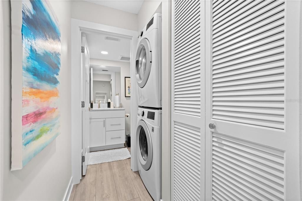 The living level of the condo features it's own half bath and also in the hallway are the full size washer and dryer, a unique find in a condo!