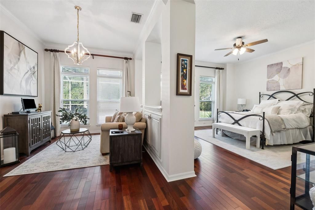 ELEGANT PRIMARY SUITE WITH SITTING AREA. CEILING TO FLOOR IMPACT WINDOWS