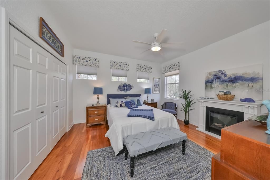 Bedroom #2 is bright with the many windows and beautiful wood flooring that matches the entire house. There is even an electric fireplace for ambiance.