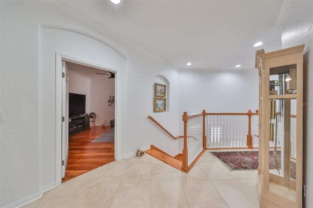 The landing at the top of the stairs is spacious, bright and open. It is the intersection for entrances into the main living area, den/office, the elevator or the secondary bedrooms and bath.