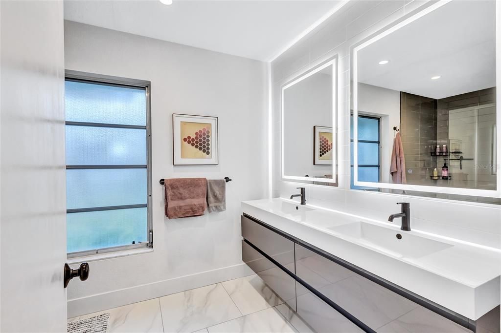 Dual sinks, lighted mirrors, high gloss luxury cabinetry