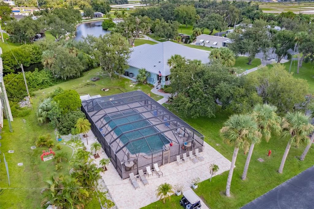 Aerial of community pool, waterfront clubhouse and dockhouse/marina area