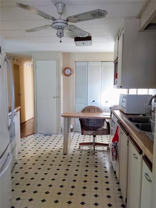 View of Desk in Kitchen Pantry and Laundry behind desk. Exit to right of desk