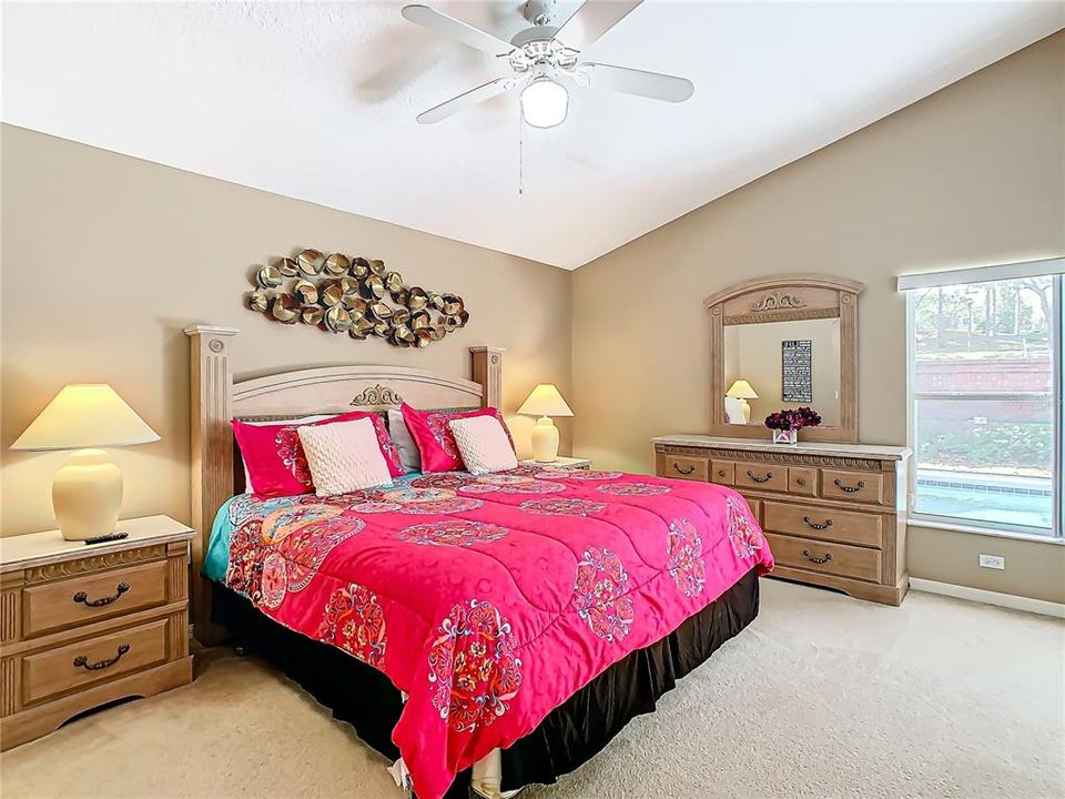 This shows the vaulted ceilings and natural light coming in from the window that looks out to the pool.