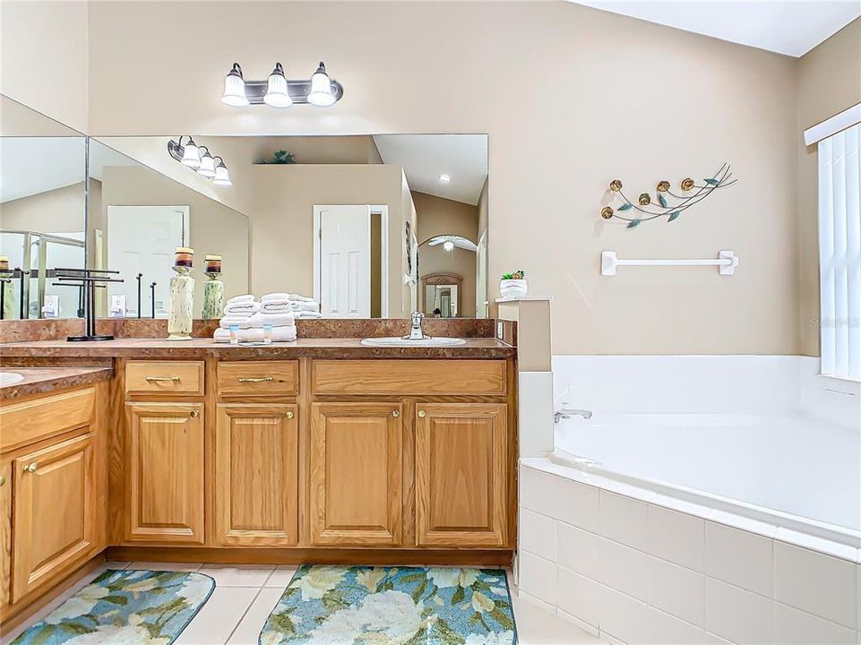 Double sinks, a garden tub, and a separate shower are in the primary bathroom.