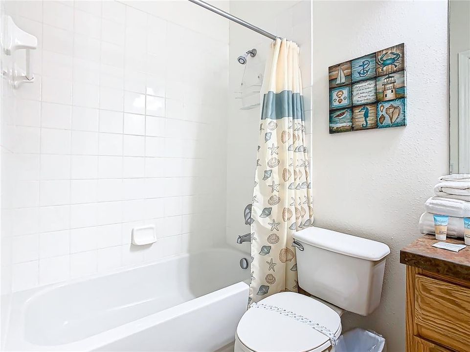 The guest bathroom has a tub and shower.