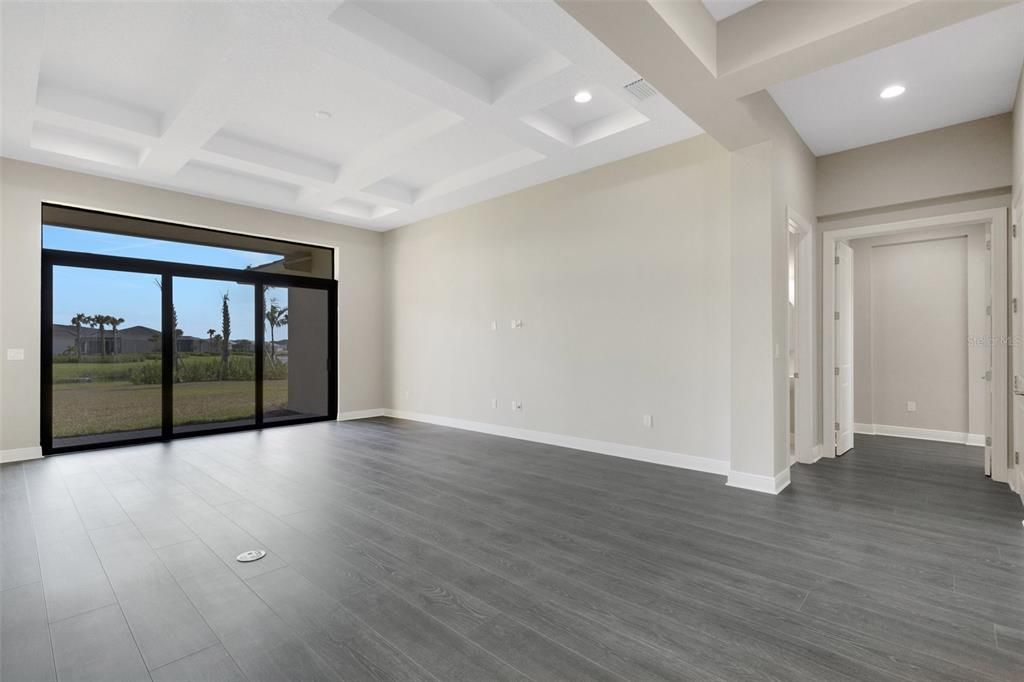 Formal living room with sliders leading out to the back yard.