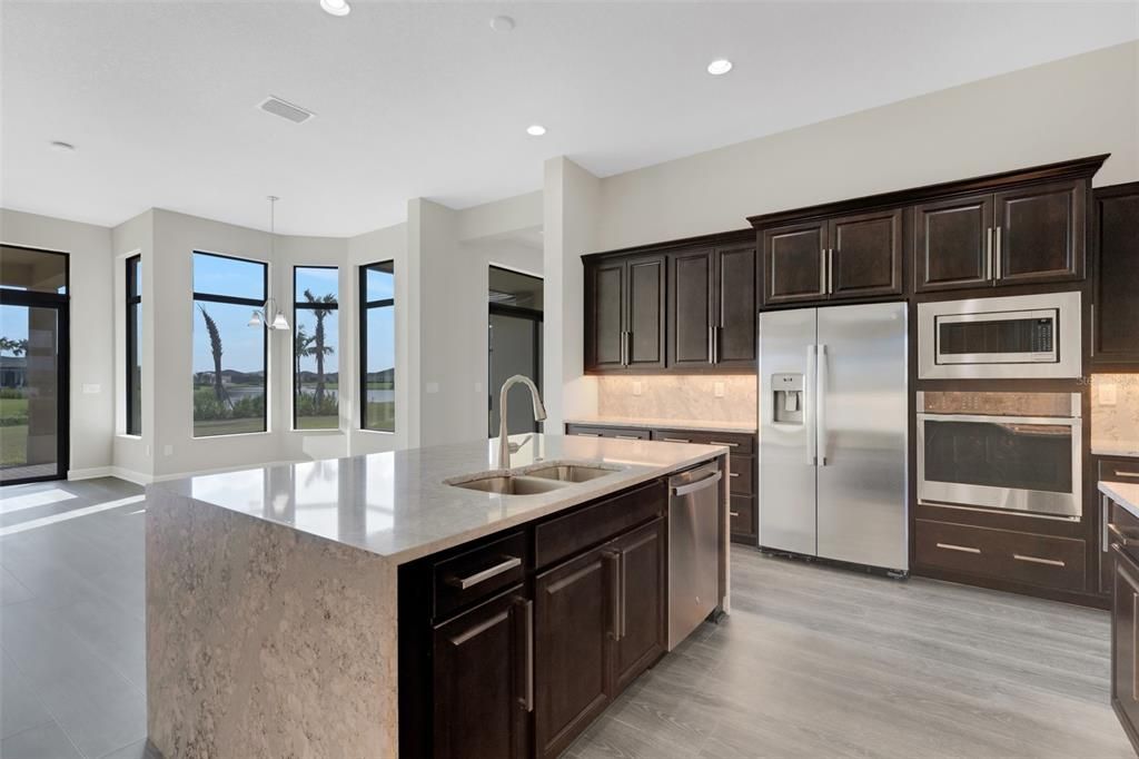 Gourmet kitchen with quartz counters, stainless steel upgraded appliances.