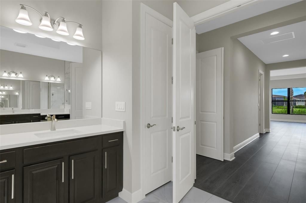 Primary bath vanity with quartz counters and brushed nickel finishes.