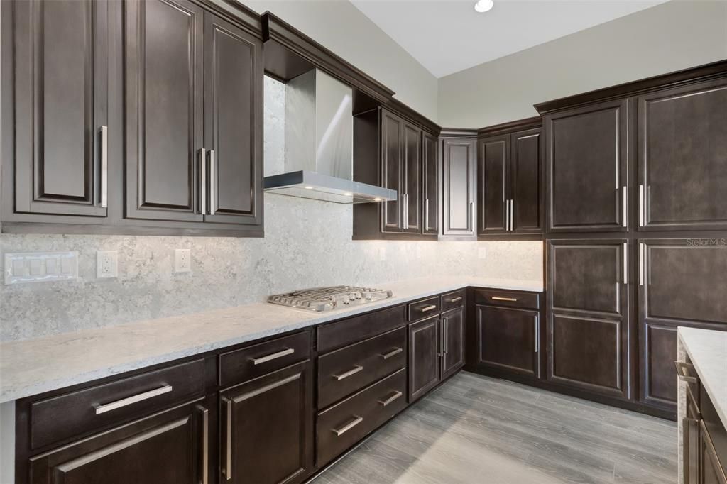 Beautiful dark wood 42 " cabinetry with crown molding.