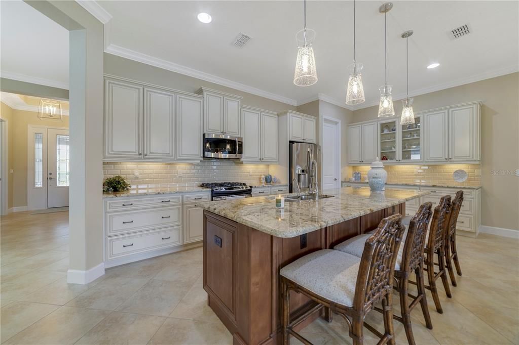 Upgraded kitchen overlooking the living areas and the serene waterfront