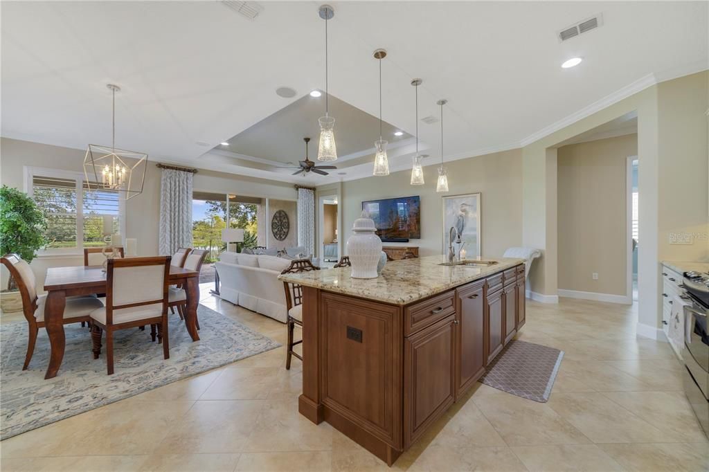 Upgraded kitchen overlooking the living areas and the serene waterfront