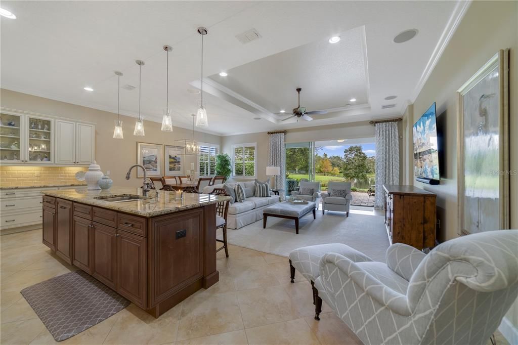 Upgraded kitchen overlooking the living areas and the serene waterfront