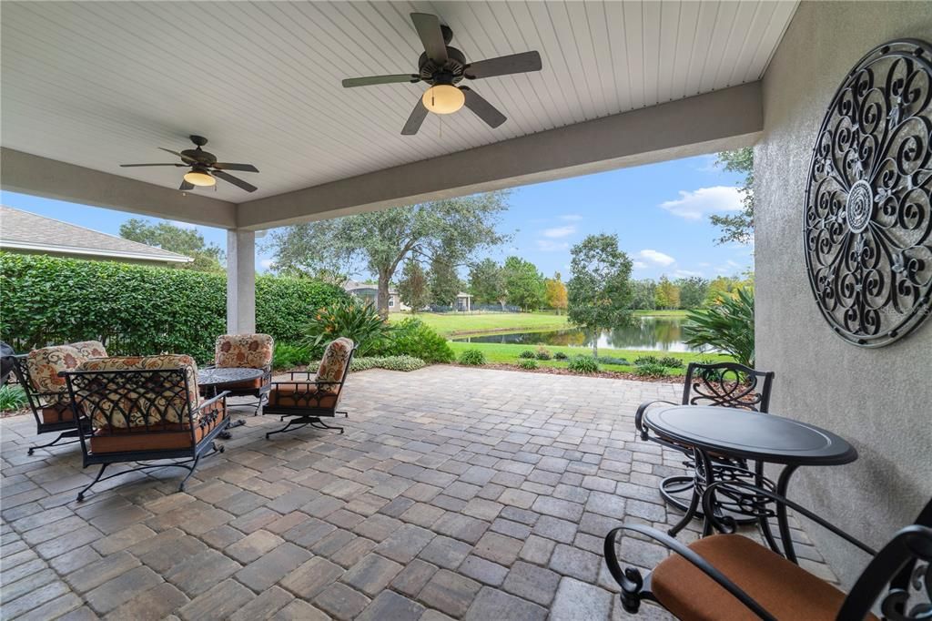 Expansive back porch with extended paver patio overlooking the water and new landscaping