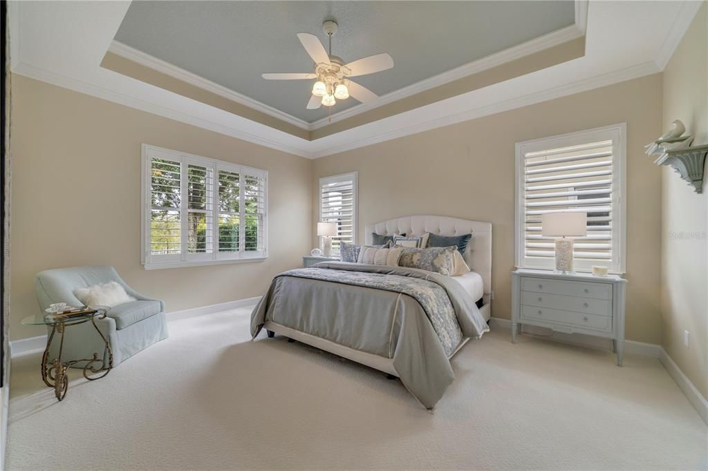 Primary bedroom situated at the rear of the home with views of the water