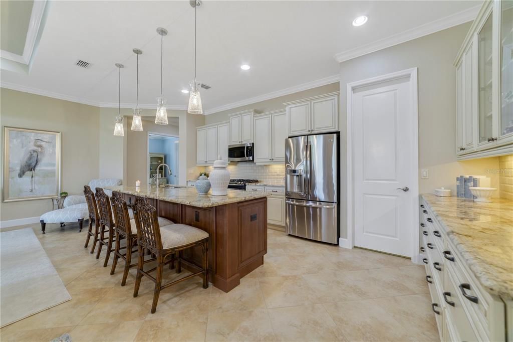 Upgraded kitchen overlooking the living areas and the serene waterfront