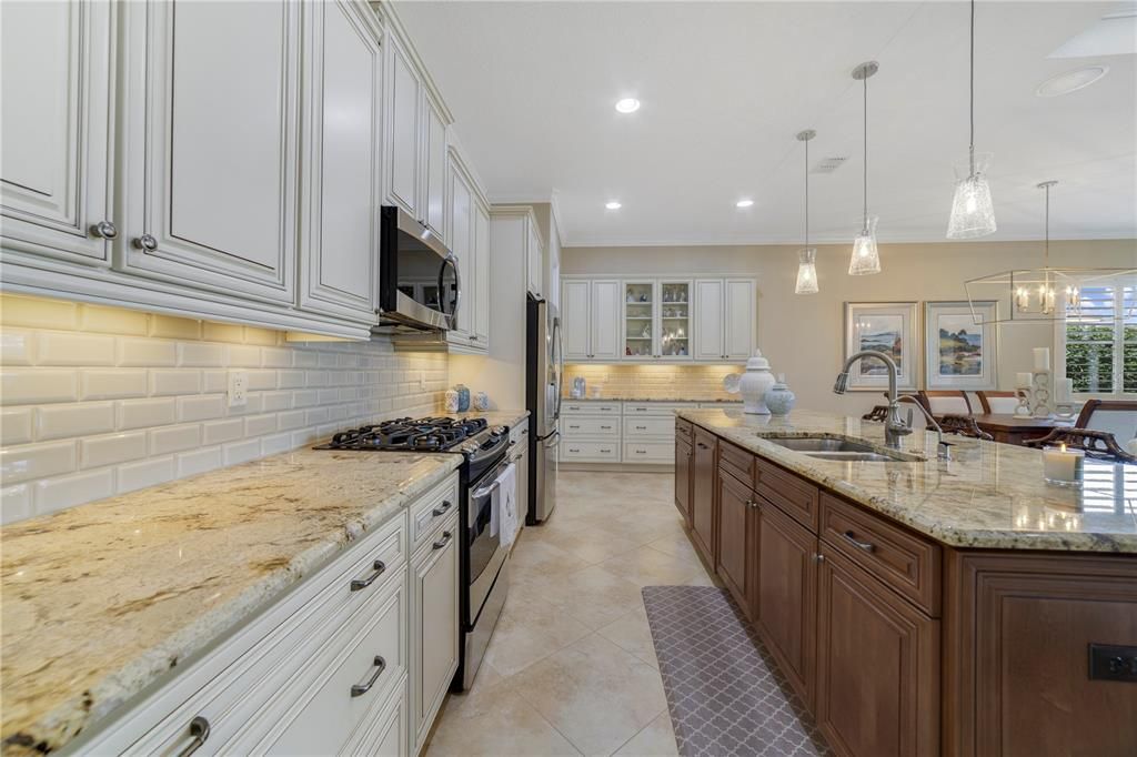 Upgraded kitchen overlooking the living areas and the serene waterfront