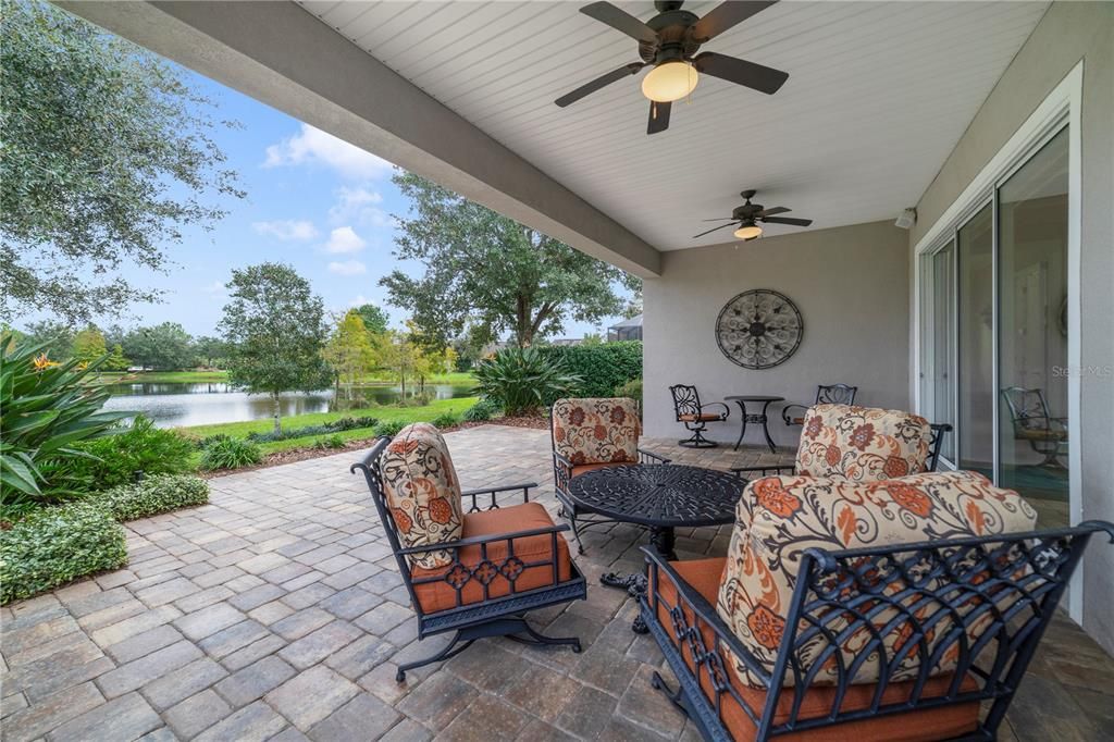 Expansive back porch with extended paver patio overlooking the water and new landscaping