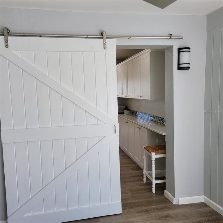 The barn door closes off the guest room/ office for privacy.