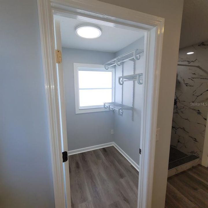 Walk-in closet in the bathroom for additional storage.