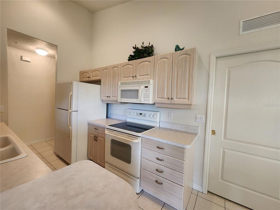 Neutral kitchen, primary bedroom on right