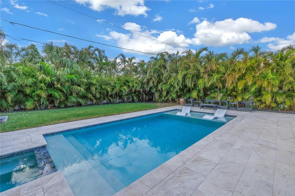 Relaxing pool surrounded by lush tropical landscaping