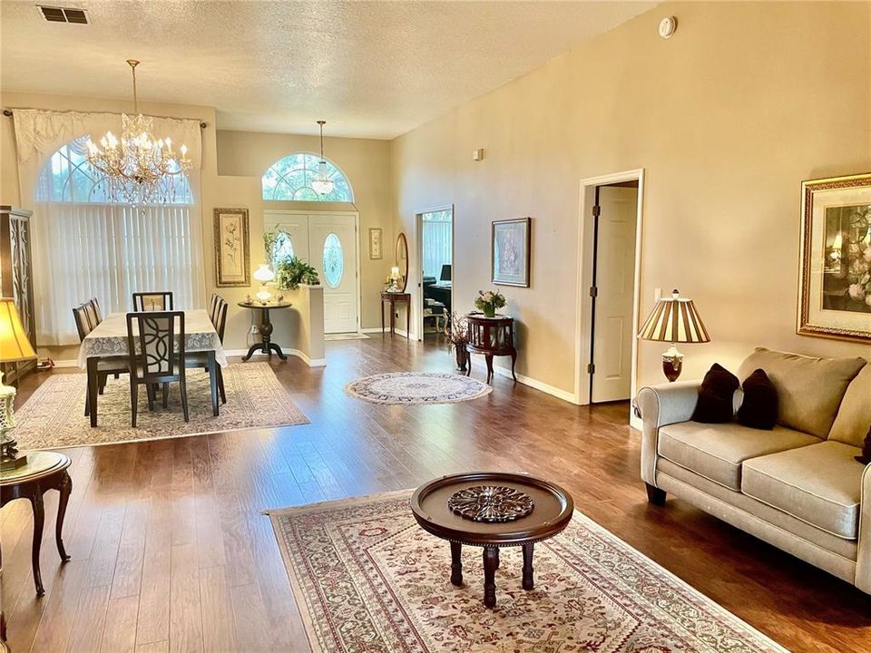 View of Living Room and Dining Room and looking AT the front door