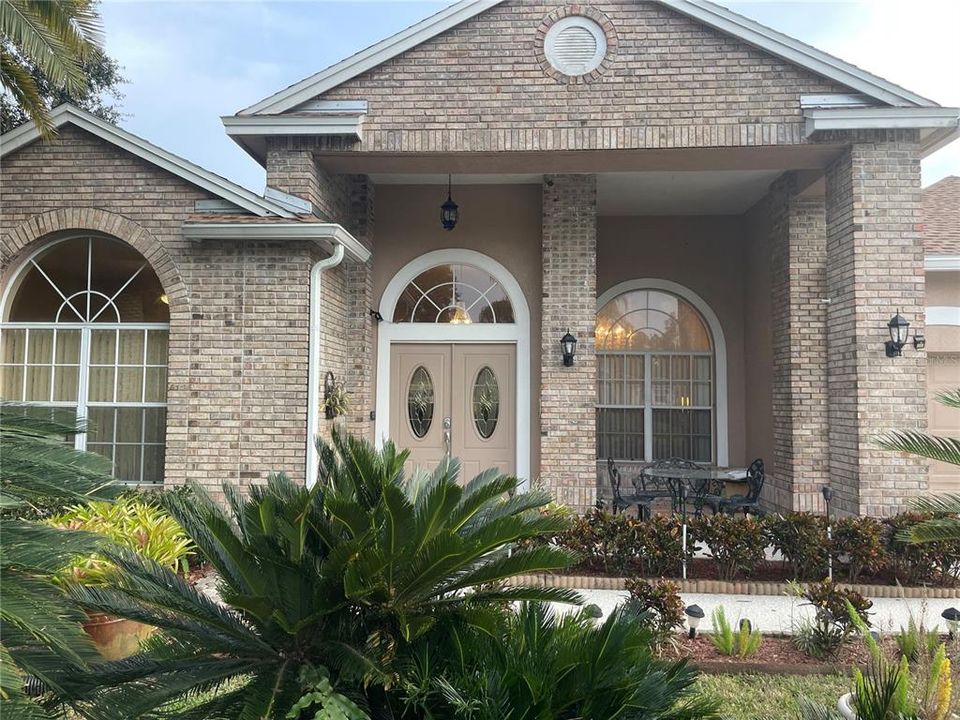 CLOSER LOOK AT FRONT OF HOUSE with PATIO AREA to the right