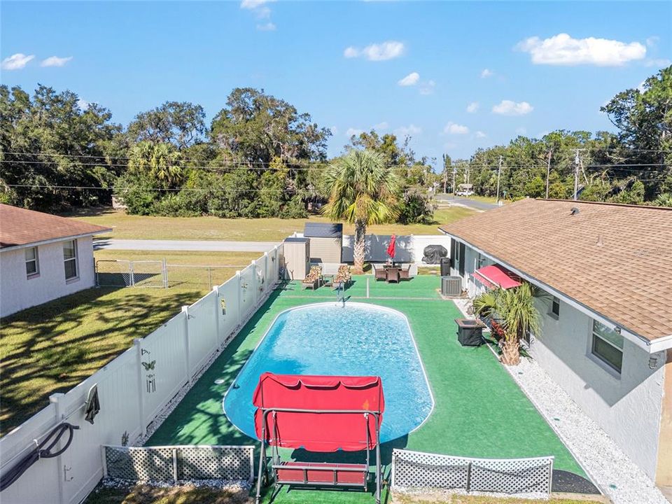 overhead backyard pool grilling area