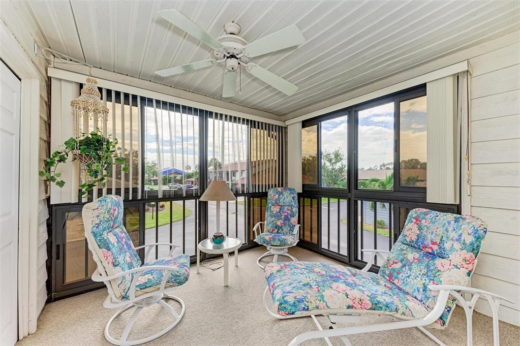 Comfortable lanai/balcony surrounded by windows