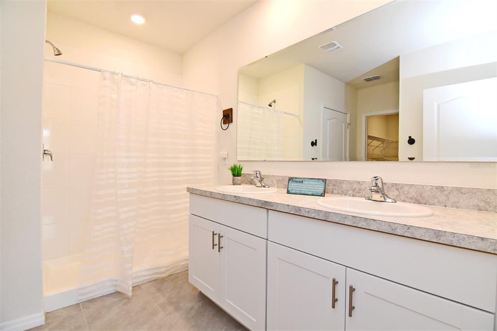 Dual sinks, walk-in shower, linen closet and a separate water closet.