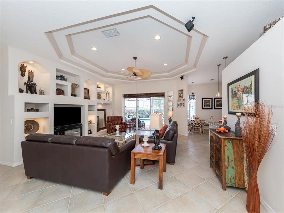 Double tray ceilings with large sliding glass doors complete this room