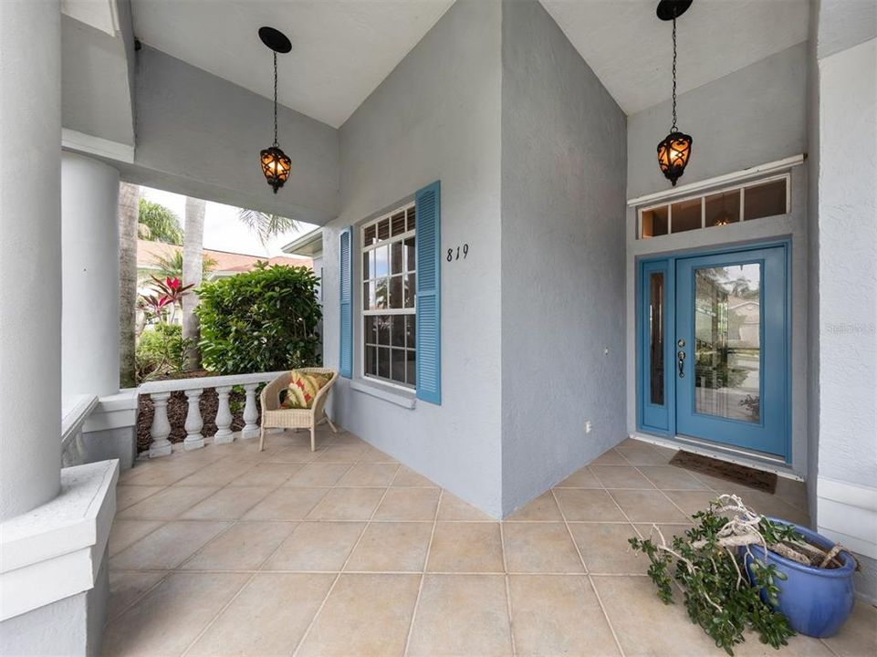 Large inviting front porch with glass door that leads to large open floor plan