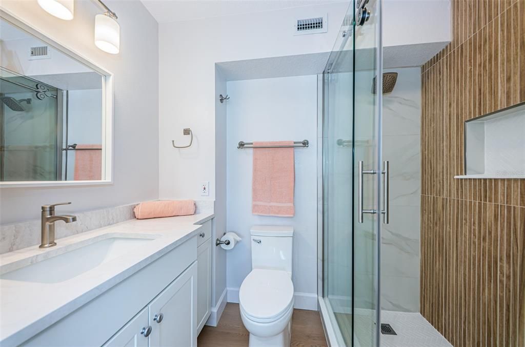 En-suite bathroom of bedroom 1 with a new step in shower.