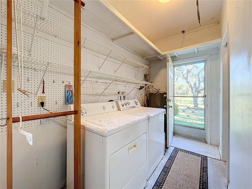 Full size laundry room with tons of storage over head and on walls. Door leads to back yard or could be seperate entrance for small apartment.