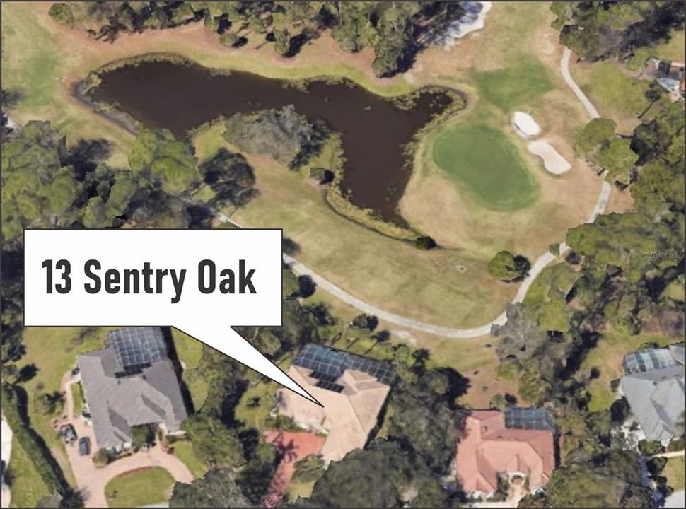 This aerial view highlights the exquisite location of 13 Sentry Oak Court in Palm Coast, Florida. Nestled alongside a beautifully maintained golf course, the property offers serene water views and direct frontage on the fairway. The lush landscaping surrounding the home enhances its privacy, while the prominent paver driveway leads to a side-entry garage. The screened pool enclosure, visible in the image, seamlessly integrates with the picturesque surroundings, providing a private retreat. This prime location combines elegance, tranquility, and a golfer’s dream setting.