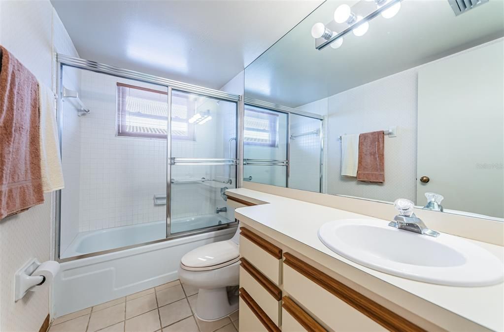 2nd bathroom with tub shower and grab bars